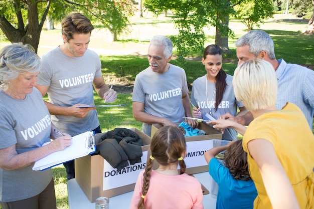 happy-volunteer-family-separating-donations-stuffs_13339-106428
