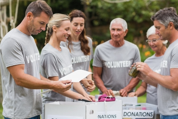 happy-volunteer-looking-donation-box_13339-135048
